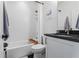 Bright bathroom featuring a shower over tub combination with white subway tile surround and black granite vanity at 658 Bull Se St, Atlanta, GA 30315