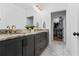 Elegant bathroom featuring double vanity, marble countertops, and a walk-in closet at 658 Bull Se St, Atlanta, GA 30315