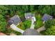 Aerial view of the home showcasing its manicured yard, a trailer, surrounding trees, and proximity to a lake at 680 Spirit Falls Way, Johns Creek, GA 30022