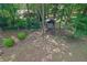 An aerial view of a spacious backyard featuring a charming treehouse and a small bridge over a dry creek bed at 680 Spirit Falls Way, Johns Creek, GA 30022