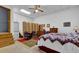 Cozy bedroom featuring a unique quilt, skylight, and additional seating area at 680 Spirit Falls Way, Johns Creek, GA 30022