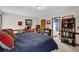 Bedroom featuring carpet, a blue bed, wooden trim, and a view of the adjacent bathroom at 680 Spirit Falls Way, Johns Creek, GA 30022