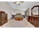 Carpeted bedroom with neutral tones, traditional wood furniture, and a ceiling fan at 680 Spirit Falls Way, Johns Creek, GA 30022