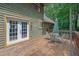 Charming outdoor deck with a dining set, ideal for outdoor entertaining with wooded backdrop at 680 Spirit Falls Way, Johns Creek, GA 30022
