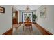 Charming dining area with wood floors, decorative lighting, and an adjacent view of the kitchen at 680 Spirit Falls Way, Johns Creek, GA 30022