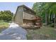 Features a two-story exterior elevation, a private driveway, and a lush backyard with mature trees at 680 Spirit Falls Way, Johns Creek, GA 30022