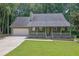 Charming single-story home with a welcoming front porch and a well-maintained front yard at 680 Spirit Falls Way, Johns Creek, GA 30022