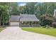 Charming home featuring a well-manicured front yard, covered porch, and a two-car garage at 680 Spirit Falls Way, Johns Creek, GA 30022