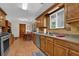 Practical kitchen with stainless steel appliances, tile floors, and views of the eating nook at 680 Spirit Falls Way, Johns Creek, GA 30022