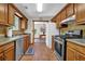 Functional kitchen with stainless steel appliances, tile backsplash, and a view into the dining area at 680 Spirit Falls Way, Johns Creek, GA 30022