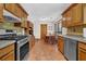 Well-equipped kitchen featuring stainless steel appliances, tiled floors, and ample counter space at 680 Spirit Falls Way, Johns Creek, GA 30022