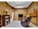 Basement living room with bookshelves, cozy chair and a television set for entertainment at 680 Spirit Falls Way, Johns Creek, GA 30022