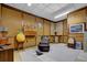 Basement living area featuring wood paneled walls, a comfortable chair, and unique decor at 680 Spirit Falls Way, Johns Creek, GA 30022