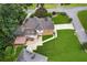 Expansive backyard with a large deck and beautiful landscaping surrounding the two-story brick home at 742 Maggie Nw Ct, Kennesaw, GA 30144