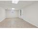 Spacious basement featuring neutral tile flooring, white walls, and ample lighting at 742 Maggie Nw Ct, Kennesaw, GA 30144