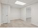A well-lit basement area featuring bright white walls and durable tile flooring at 742 Maggie Nw Ct, Kennesaw, GA 30144