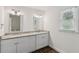 Bathroom features a double sink vanity with granite counters, wood look floors, and a window at 742 Maggie Nw Ct, Kennesaw, GA 30144