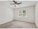 Bedroom features carpeted floors, a ceiling fan, and natural light from a window at 742 Maggie Nw Ct, Kennesaw, GA 30144