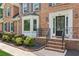 Brick steps leading to front door, with manicured landscaping and black shutters at 742 Maggie Nw Ct, Kennesaw, GA 30144