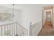 Upstairs hallway featuring a decorative window, fresh paint and plush carpet at 742 Maggie Nw Ct, Kennesaw, GA 30144