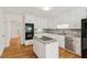 Kitchen with white cabinets, granite countertops, stainless steel appliances, and hardwood floors at 742 Maggie Nw Ct, Kennesaw, GA 30144