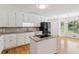Updated kitchen showcases granite countertops, a kitchen island with cooktop, and stainless steel appliances at 742 Maggie Nw Ct, Kennesaw, GA 30144
