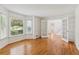 Sunlit living room with hardwood floors, white trim, and french doors at 742 Maggie Nw Ct, Kennesaw, GA 30144