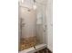 A tiled shower behind a glass door includes two shower heads and a built in shelf at 742 Maggie Nw Ct, Kennesaw, GA 30144