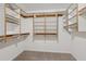 Spacious walk-in closet with a carpet floor and multiple shelves and hanging rods at 742 Maggie Nw Ct, Kennesaw, GA 30144