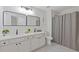 Bathroom featuring double sink vanity, quartz countertops, and a tiled shower at 1464 Dolcetto Trce, Kennesaw, GA 30152