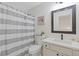 Bathroom featuring white vanity, framed mirror, and a shower with a gray and white striped curtain at 1464 Dolcetto Trce, Kennesaw, GA 30152