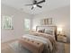 Cozy bedroom with a ceiling fan, natural light, neutral tones, and stylish decor at 1464 Dolcetto Trce, Kennesaw, GA 30152