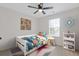 Bedroom featuring neutral walls, a modern ceiling fan, and bright, playful decor at 1464 Dolcetto Trce, Kennesaw, GA 30152
