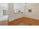Bright dining room featuring hardwood floors, wainscoting, and a modern chandelier at 1464 Dolcetto Trce, Kennesaw, GA 30152
