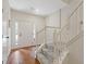 Bright entryway with hardwood floors, white door, and carpeted stairs with white railing at 1464 Dolcetto Trce, Kennesaw, GA 30152