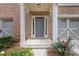 Inviting front porch with brick accents and colorful landscaping at 1464 Dolcetto Trce, Kennesaw, GA 30152