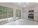 Kitchen with stainless steel appliances, white cabinets, and access to the backyard deck at 1464 Dolcetto Trce, Kennesaw, GA 30152