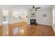 Open-concept living room featuring beautiful hardwood floors, a fireplace, and lots of natural light at 1464 Dolcetto Trce, Kennesaw, GA 30152