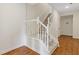 Carpeted stairway with white wood railing and banister in a home with wood flooring at 1464 Dolcetto Trce, Kennesaw, GA 30152