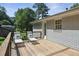 Back deck featuring lounge chairs and a wooden railing overlooking a well-manicured lawn at 3120 Mary Dr, Marietta, GA 30066