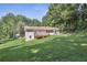 Spacious backyard with a deck and patio, surrounded by lush trees at 3120 Mary Dr, Marietta, GA 30066