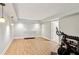 Basement area with stationary bike and dumbbells, wood-look flooring, and a dresser at 3120 Mary Dr, Marietta, GA 30066