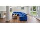 Finished basement with blue sectional sofa and sliding doors to the backyard at 3120 Mary Dr, Marietta, GA 30066