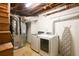 Basement utility area with modern washer and dryer units, plus an ironing board at 3120 Mary Dr, Marietta, GA 30066