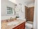 Bathroom featuring a vanity with granite countertop and a tiled shower at 3120 Mary Dr, Marietta, GA 30066