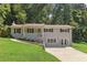 Charming, split-level home featuring a manicured lawn and lovely brick exterior at 3120 Mary Dr, Marietta, GA 30066