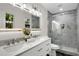 Luxurious bathroom with double vanity, sleek mirrors, and tiled glass shower at 3288 Tarragon Dr, Decatur, GA 30034
