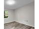 Clean bedroom featuring laminate floors and a window overlooking trees at 3288 Tarragon Dr, Decatur, GA 30034