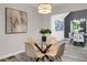 Bright dining area features a modern light fixture and flows into the kitchen area for easy entertaining at 3288 Tarragon Dr, Decatur, GA 30034