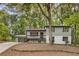 Inviting two-story home with a charming front porch and a well-maintained landscaped yard at 3288 Tarragon Dr, Decatur, GA 30034